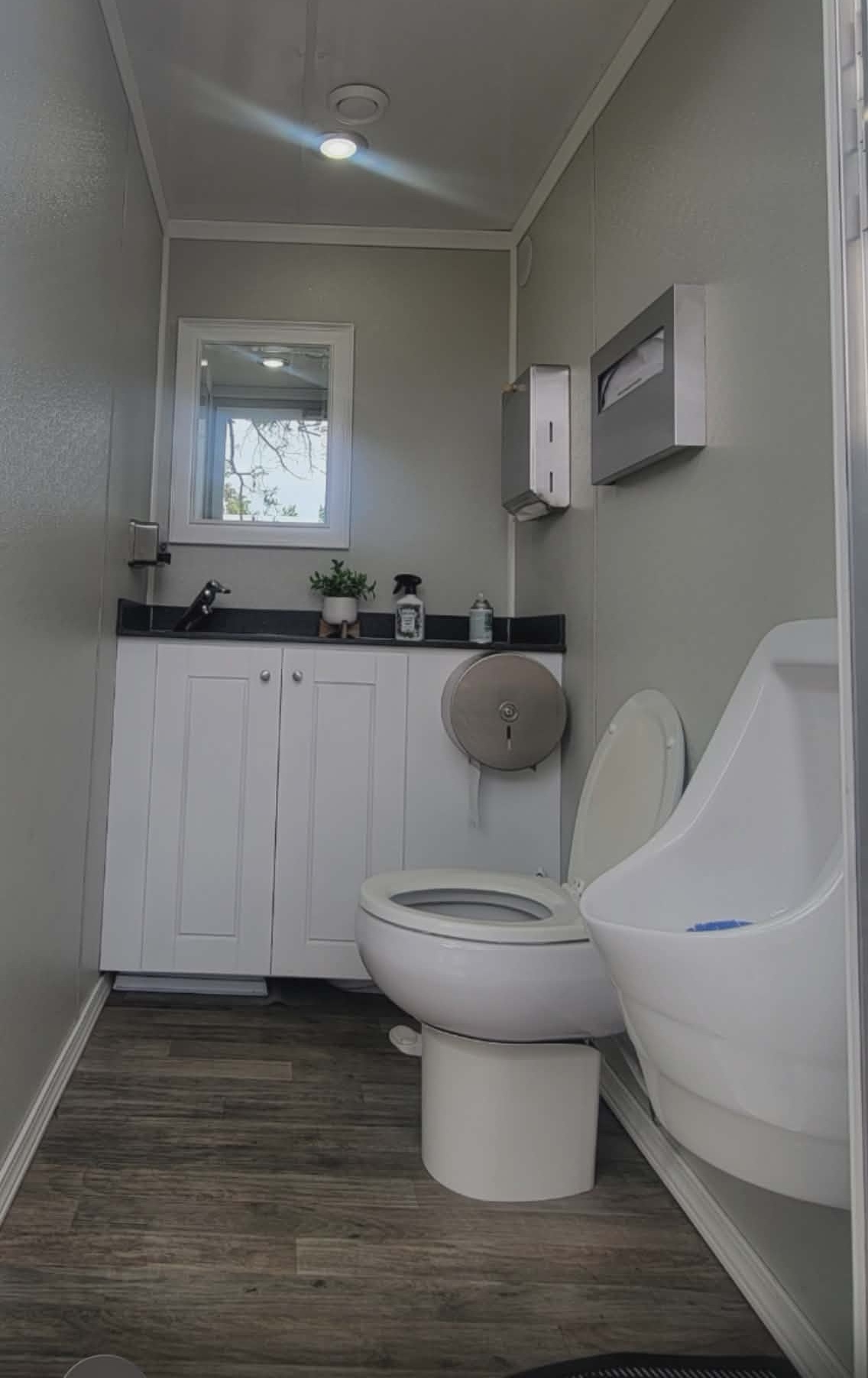 KLASSIK Restrooms 3-Unit Men's Suite Interior — White Vanity, Urinal, Window, Wood Floors